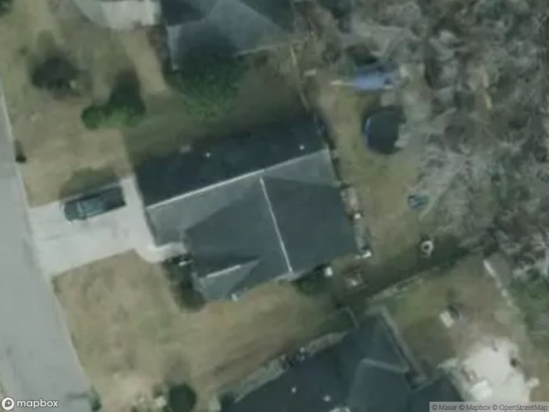 Aerial view of residential area with several houses and a driveway.