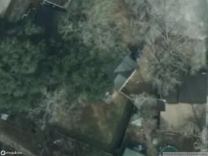 Aerial view of residential area with houses and trees.