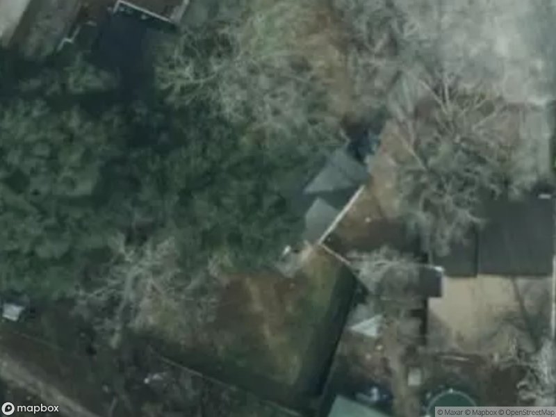 Aerial view of residential area with houses and trees.