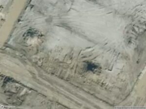 Aerial view of a barren landscape with dirt and excavation marks.
