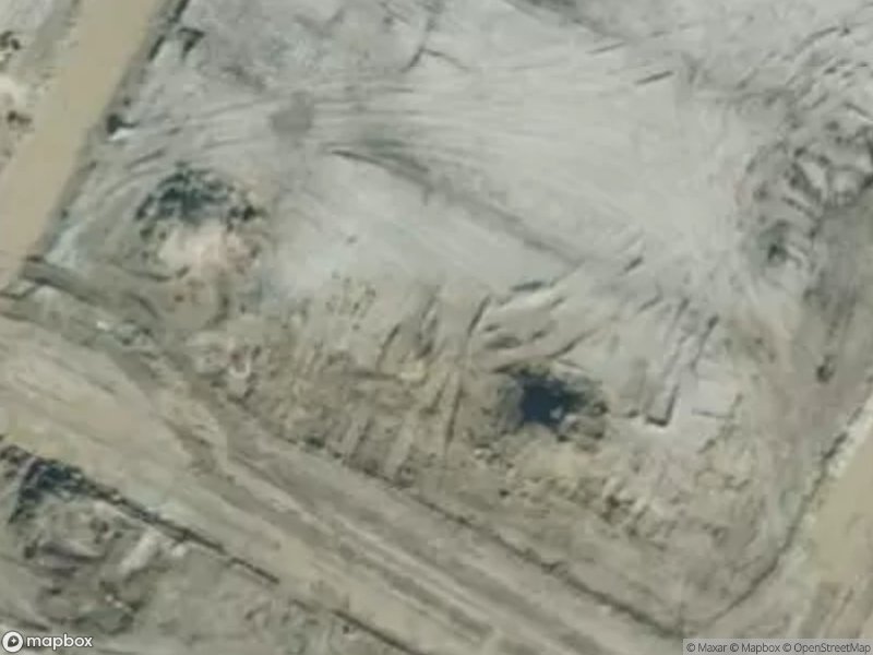 Aerial view of a barren landscape with dirt and excavation marks.