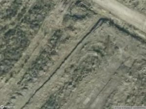 Aerial view of a rugged terrain with visible pathways and cleared areas.