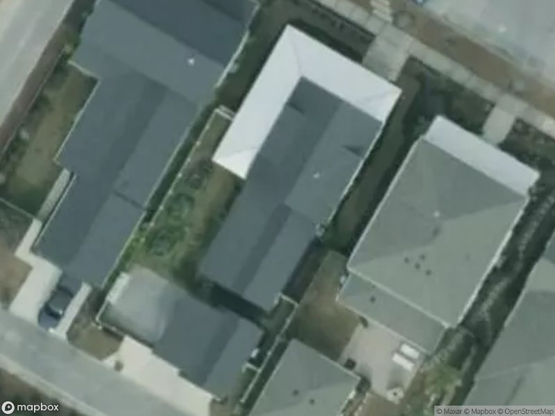 Aerial view of several residential houses with gray roofs and surrounding driveways.