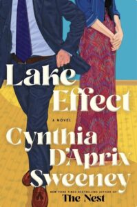 A man in a suit and a woman in a colorful dress stand together, with the title "Lake Effect" prominently displayed.