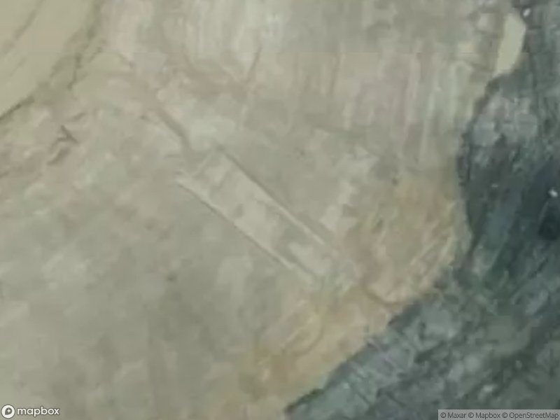 Aerial view of a rugged terrain with distinct geological patterns and varying colors.