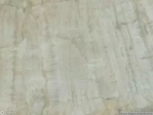 Satellite image shows a textured, light-colored surface with subtle variations.