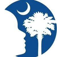 Silhouette of a face with a crescent moon and palm tree in a blue circle.