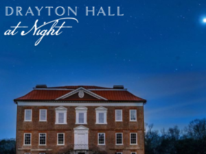Drayton Hall illuminated at night against a starry sky, showcasing its historic architecture.